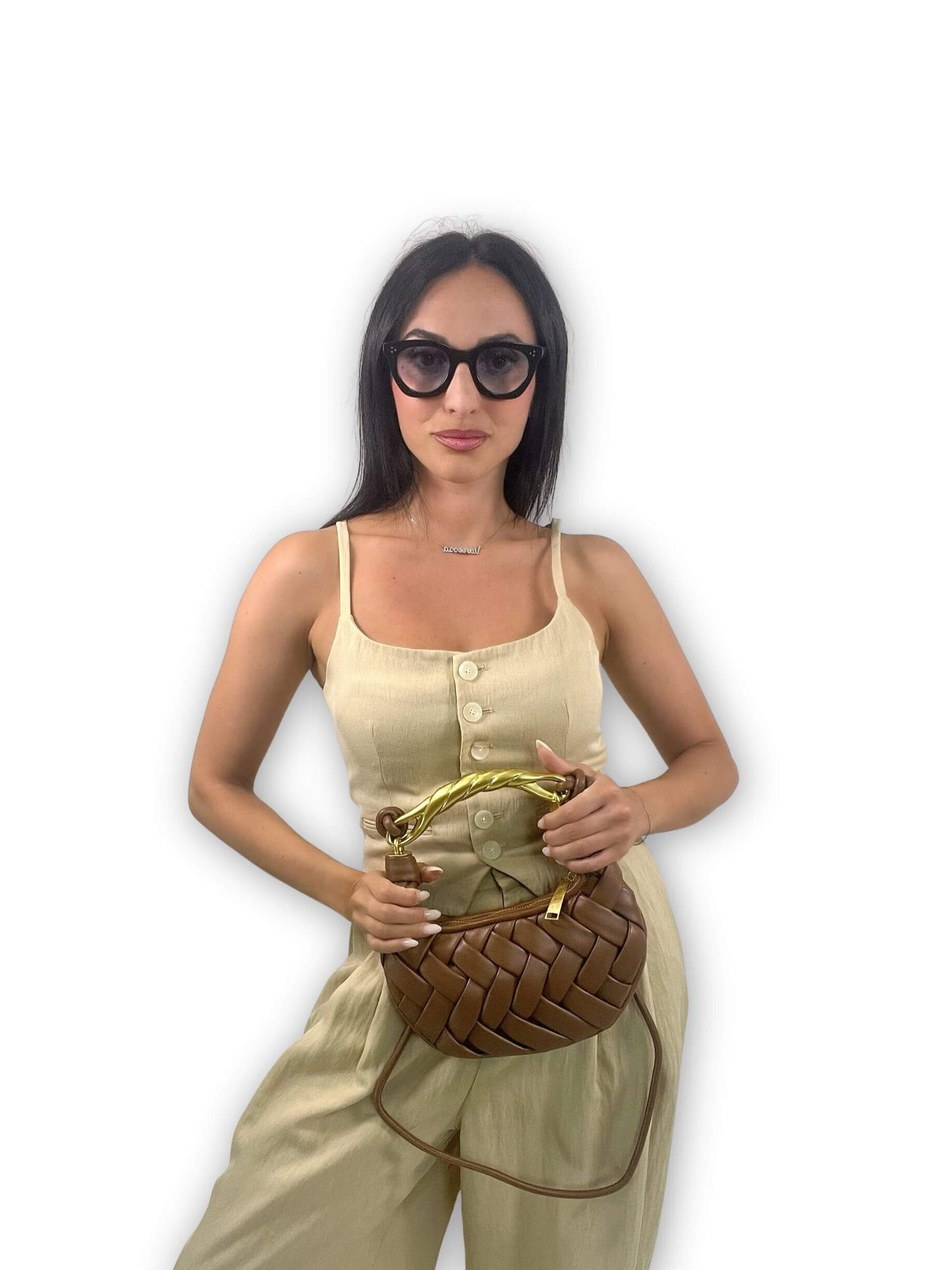 Donna con borsa marrone in pelle intrecciata e manico dorato scultoreo